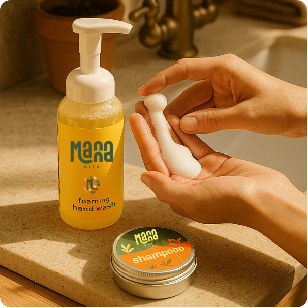 Manna Oils foaming soap bottle in hand — gentle, natural cleanser for everyday use.
