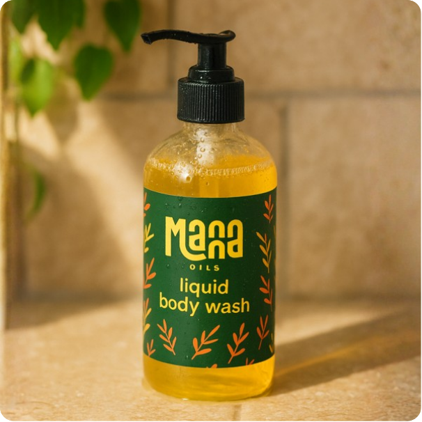 Manna Oils liquid body wash in a green bottle — nourishing, plant-based cleanser for radiant skin.