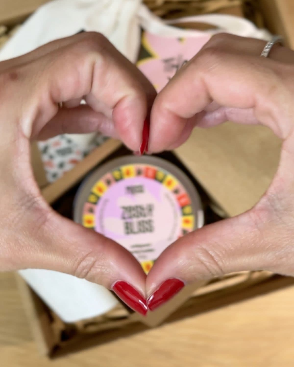 Yulia making a heart above a Manna Zesty Bliss parcel